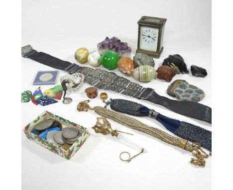 A collection of polished hardstone eggs, rock samples, coins and a carriage clock