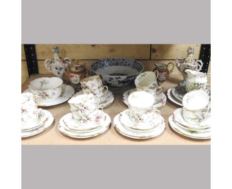 An early 20th century Staffordshire tea service, decorated with flowers, with twelve place settings, made for Harrod's Limite