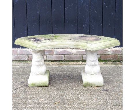 A cast stone curved garden bench, on squirrel supports, 45cm high