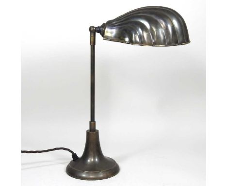 A modern brass desk light, with a shell shaped shade, 40cm high