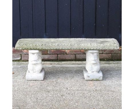 A cast stone garden bench, on squirrel supports113w x 36d x 39h cm