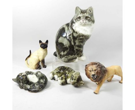 A large Winstanley pottery cat, 28cm high, together with two smaller, a Beswick model of a lion and a Siamese cat (5)