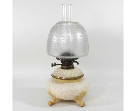 An early 20th century pottery oil lamp, with a Messeanger's patent and etched glass shade, 47cm high
