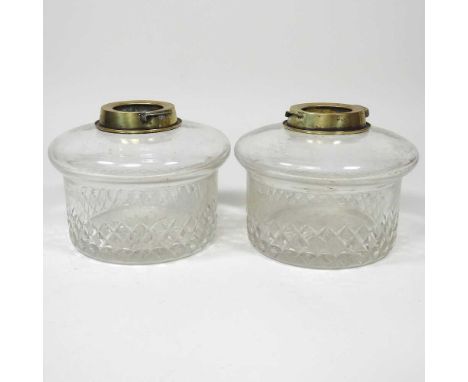 A pair of cut glass oil lamp fonts. each 14cm diameter (2)Both are dirty and worn to the base, with light surface marks. No v