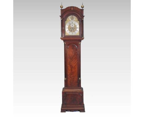 A George III mahogany cased longcase clock, surmounted by brass finials, the arched brass twelve inch dial, with strike silen