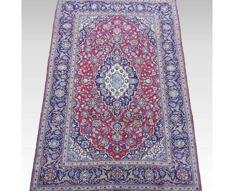 A Persian carpet, with all over floral designs, on a red field, 305 x 200cmOverall light signs of use. The colours have run s