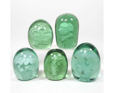 A collection of five Victorian green glass dump weights, to include examples with floral and portrait inclusions, 10cm high (