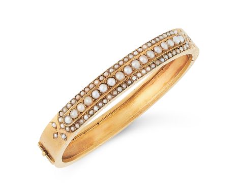 AN ANTIQUE PEARL BANGLE, LATE 19TH CENTURY in high carat yellow gold, half set with three rows of pearls, with pearl set tref