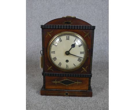 A 19th century mahogany and brass inlaid dome topped mantle clock, the white painted dial with black Roman numerals and appli