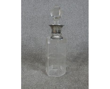 A George V hallmarked silver collared glass decanter, with applied silver Whiskey decanter / spirit label. H.30 W.9 D.9cm 