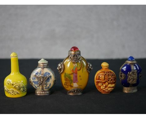 Five Chinese 20th century snuff bottles, including a reverse painted glass bottle with geisha design and metal lion head fram
