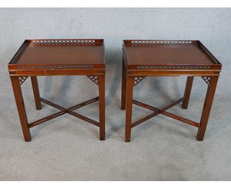 A pair of reporoduction mahogany lamp tables in Chippendale style, of rectangular form with a pierced gallery, the square sec