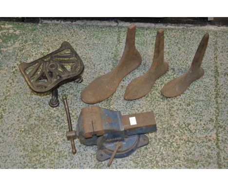 A cast iron trivet; a cast iron bench vice; a set of male, female and child shoe lasts