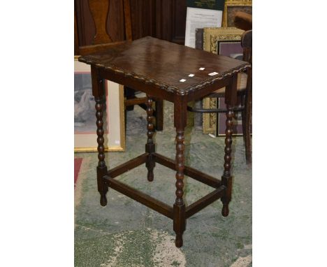 An oak occasional table, shaped rectangular top, bobbin turned supports.