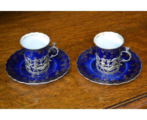 A pair of Royal Vienna cups and saucers, cherub mounts, Sheffield 1907