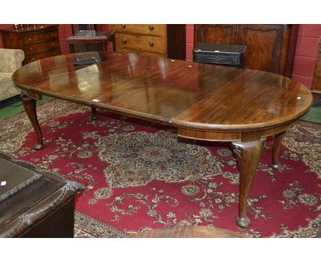 A Chippendale revival mahogany wind out dining table, circa 1910, two leaves and winding handle.