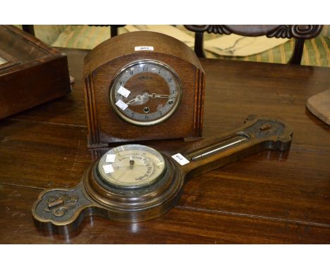 An oak mantel clock; and oak wheel barometer, c.1930 (2)