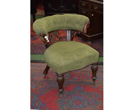 A Victorian horseshoe chair, carved and pierced splat, padded back, sprung seat, turned and carved legs, ceramic casters, c.1