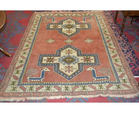 A Middle-Eastern carpet, in shades of coral and blue