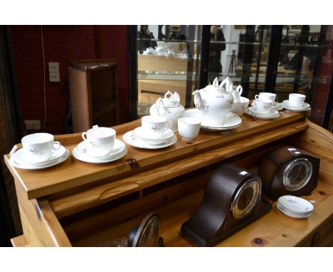 An English porcelain six-setting tea service, picked out in gilt with floral sprigs, comprising a teapot, milk jug, two-handl