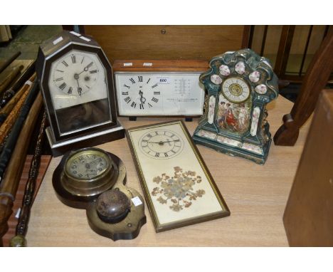 A wall mounted alarm clock; a ceramic mantel clock; a wood case mantel clock; a Vaga clock/weather station; another wall cloc