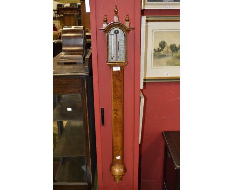 An O Comitti & Sons Ltd walnut mercury stick barometer, alcohol thermometer, gilt spire finials, turned cistern cover, the ba