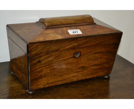 A Victorian sarcophagus shaped walnut tea caddy, with glass insert, and key.
