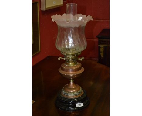 A Victorian copper and glass oil lamp, spiralled and frosted glass shade