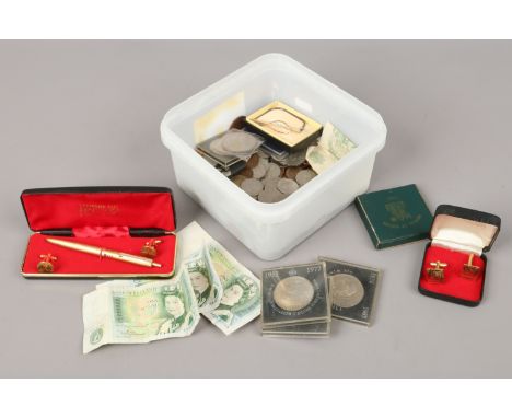 A box of British pre-decimal coins cased commemorative crowns, three one pound notes, cufflinks and a pen.