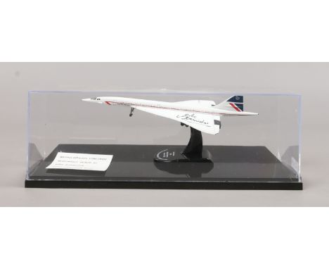 A scale model of Concorde in display case signed by Mike Bannister (Chief Concorde pilot). Plane 17cm.