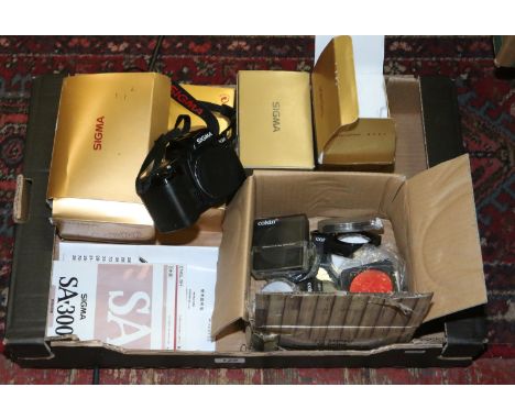 Photographic interest; a box containing assorted lenses, filters and a camera body including Sigma.