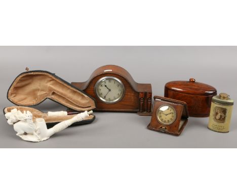 An Edwardian eight day oak cased mantel clock, leather cased folding travel clock, cased carved meerschaum pipe and a carved 