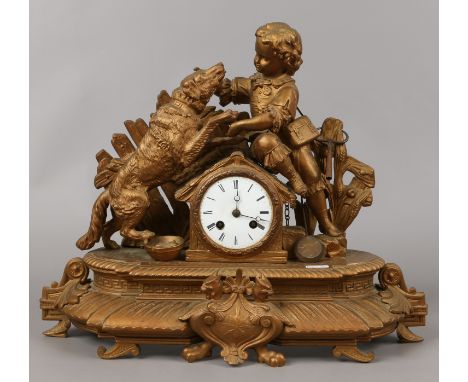 A C19th French gilt metal mantel clock surmounted with a boy and his dog with a white enamel dial, Roman numeral markers hous