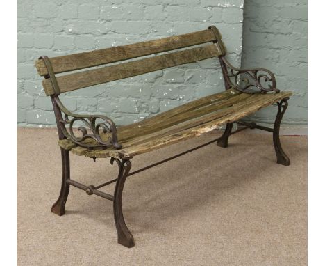An antique cast iron bench with scrolling arms.