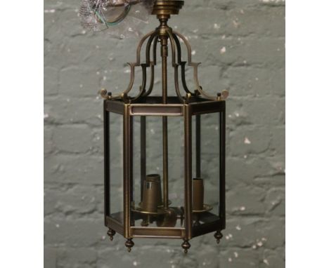 A new and unused antique brass effect 3 branch hall lantern with clear bevel edge glass panels