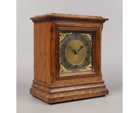 An oak cased eight day bracket clock by Winterhalder & Hofmeier with square brass dial adorned with spandrels and silvered ch
