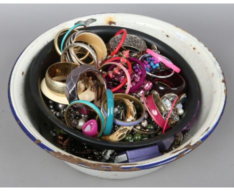 A vintage basin and contents of costume jewellery to include bangles, necklaces, earrings etc.