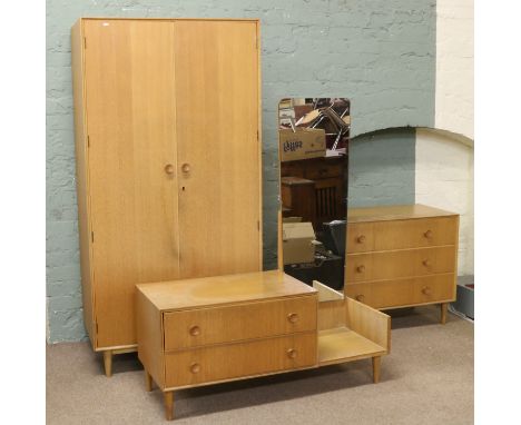 A light oak three part bedroom suite comprising two door wardrobe, mirrored chest/dressing table and three drawer chest raise