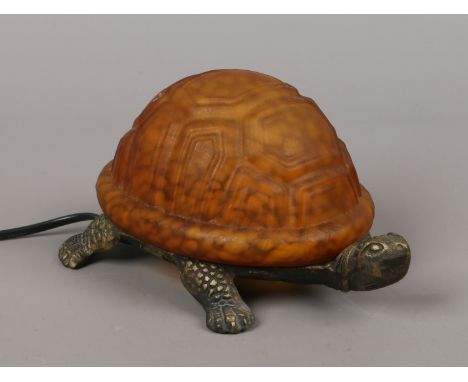 A gilt metal and opaque glass table lamp formed as a tortoise.