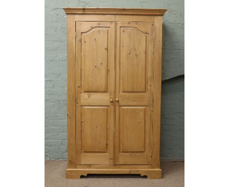 A panelled pine double wardrobe.
