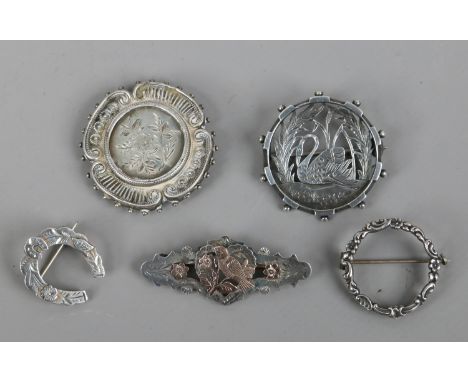 Five silver brooches including antique examples.