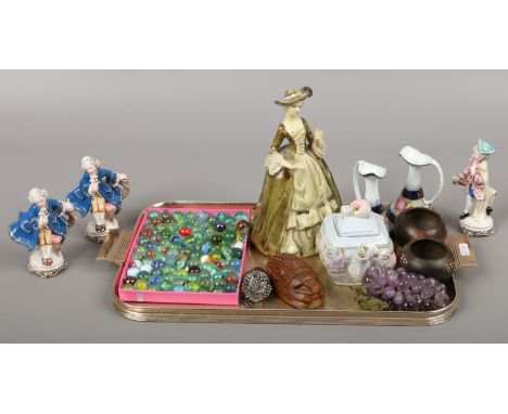 A tray of collectables including vintage polychrome marbles, continental ceramic figures and amethyst grapes etc.