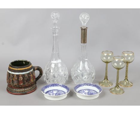 A German decanter with silver collar, another glass decanter, pair of Royal Doulton willow pattern wine coasters, three Bohem