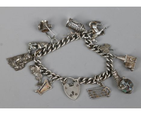 A silver charm bracelet with heart shaped clasp, 50 grams.