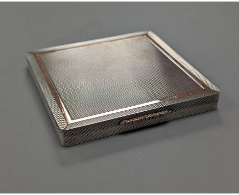 A 1960's Garrard &amp; Co yellow metal mounted engine turned silver cigarette case, Birmingham, 1965, 88mm.