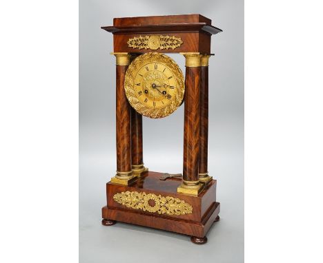 An early 19th century mahogany portico clock with three keys and spare bell, 50cm