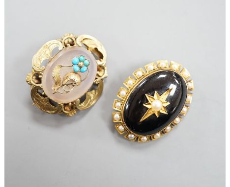 Two Victorian yellow metal and gem set oval brooches, including black enamel and split pearl, largest 34mm.