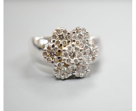 A modern 14k white metal and seven stone diamond set multi-cluster flower head dress ring, size M/N, gross weight 8.4 grams.