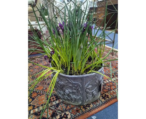 A circular lead planter moulded with Bacchic putti, diameter 30cm