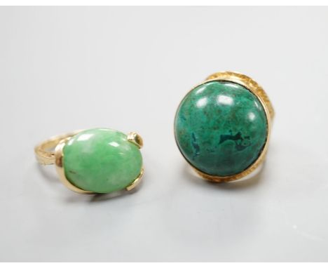 A modern 14k yellow metal and cabochon malachite set dress ring, size F and a similar cabochon jade set ring, size K, gross w